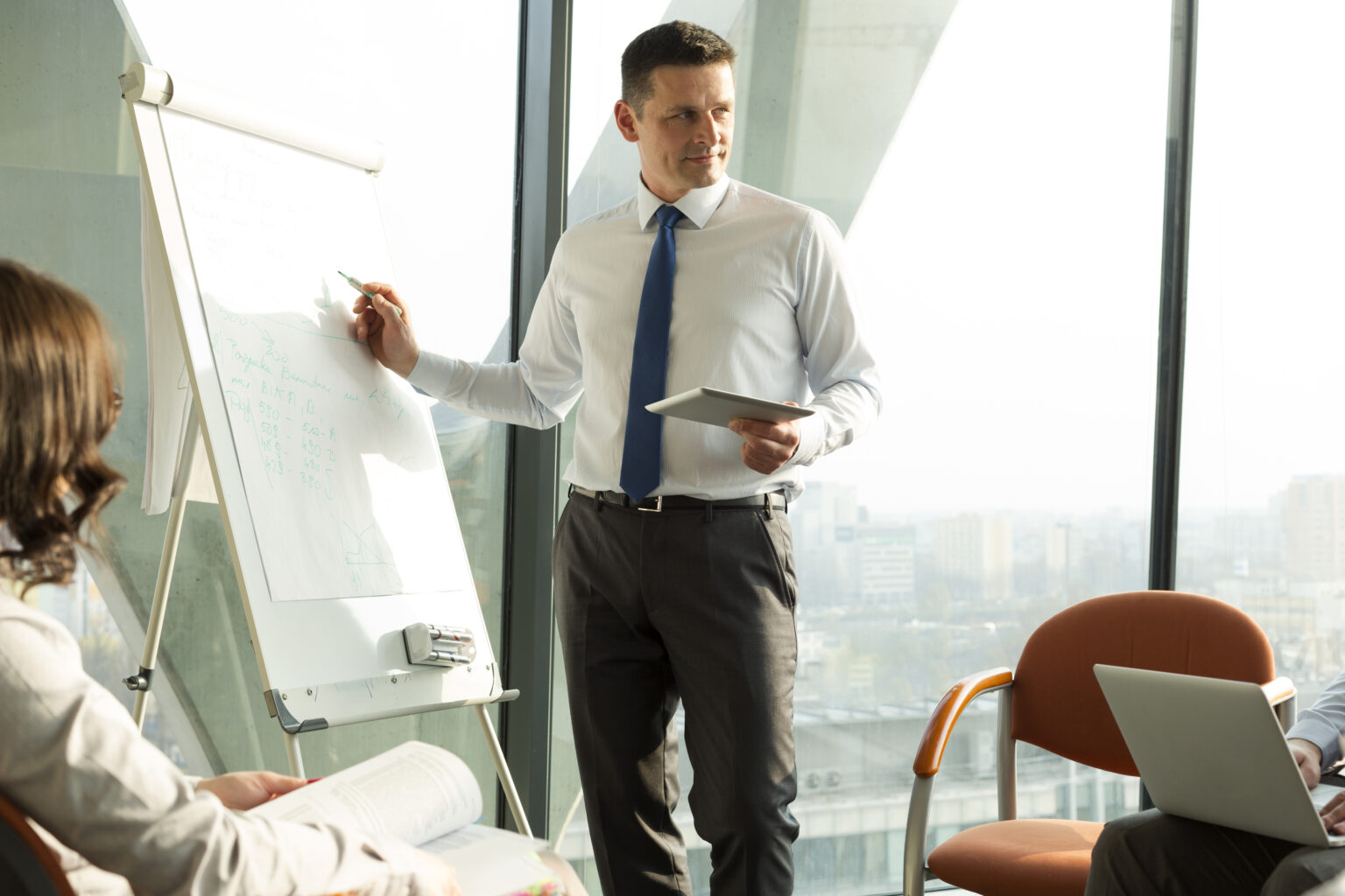 Businessman at flip chart leading a seminar